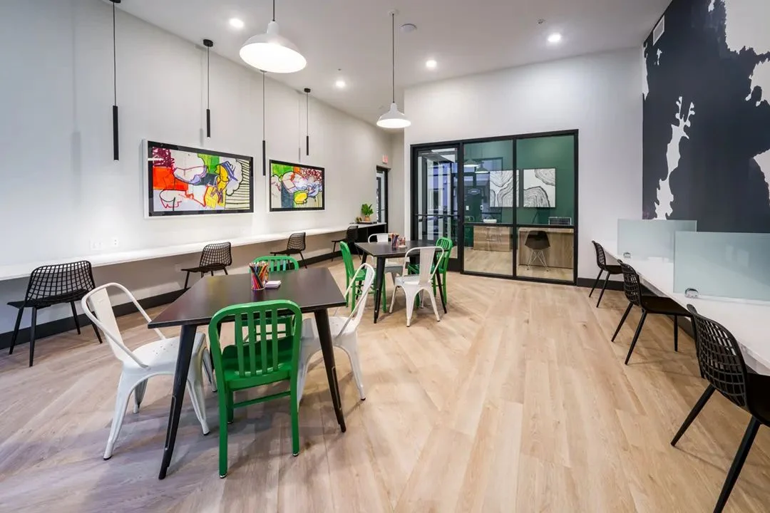 Work-from-home lounge with bar seating and colorful chairs at Anton Viridian