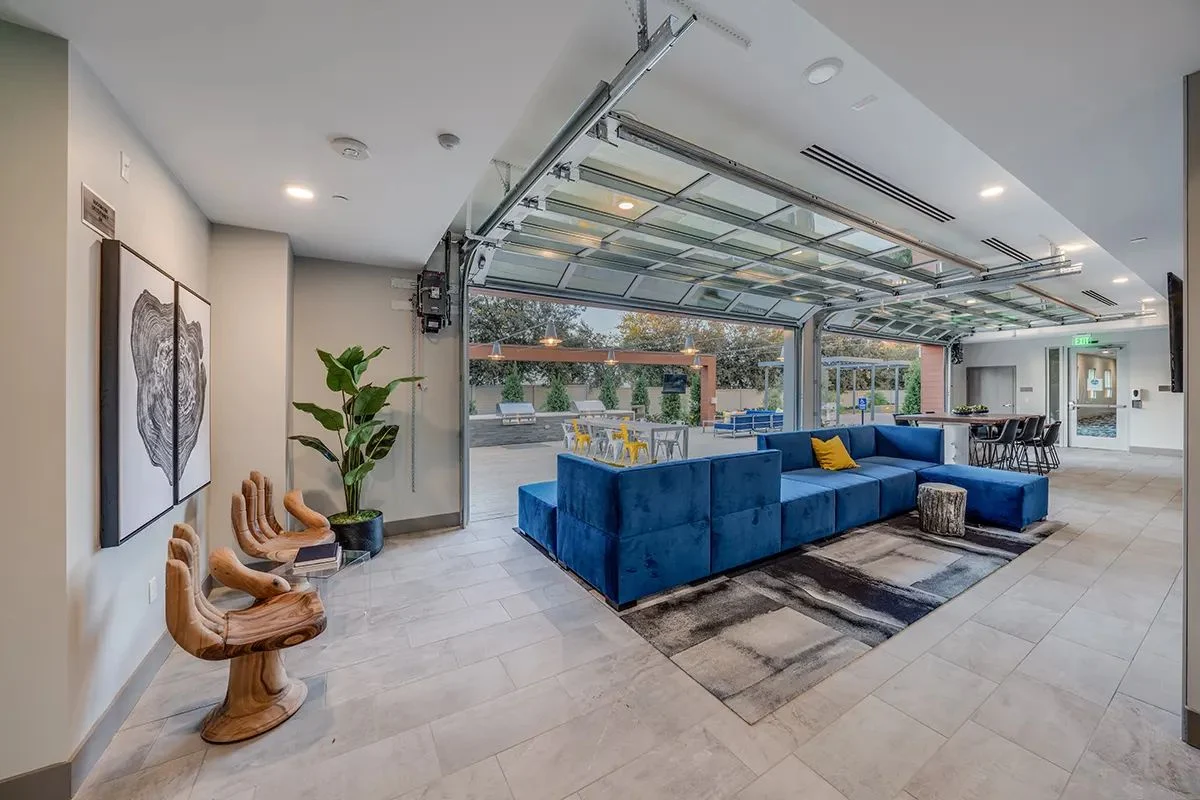 Anton Ladera common space with modular furniture opening to the outdoors